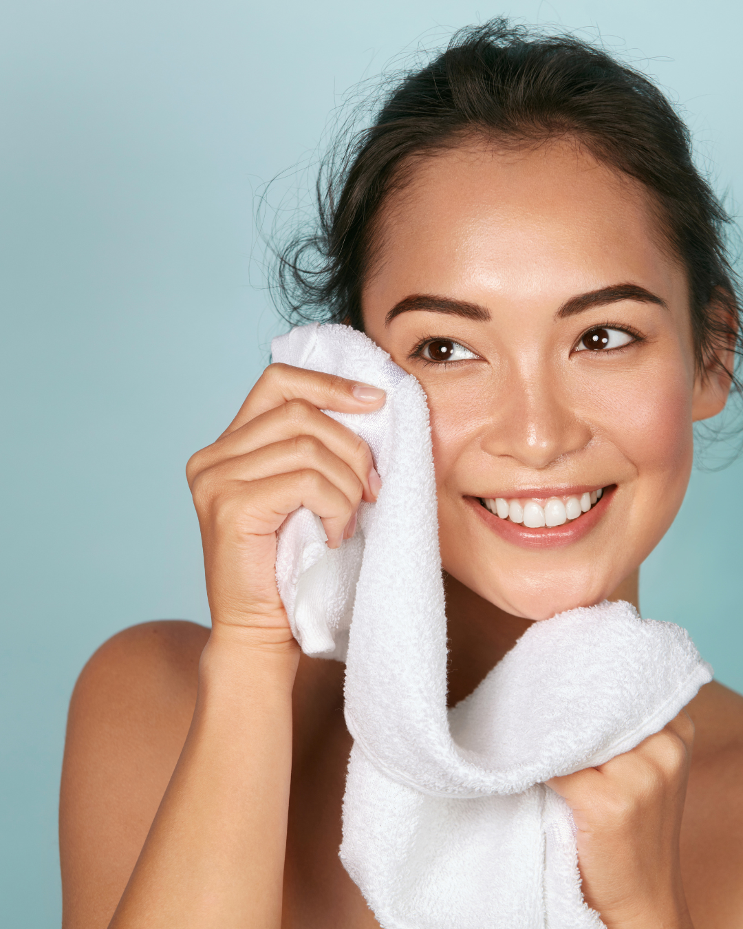 woman showing clean face and smiling after using mythic makeup breakup pre-cleansing oil